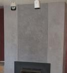 Trowelable overlay was used to fill the grout lines and smooth over the existing bricks on this fireplace/chimney. Several, thin layers of pigmented cement micro-topping were then troweled over all areas to give it the look of a large concrete column..