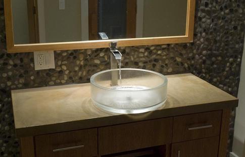 This concrete vanity is acid stained with an epoxy finish.